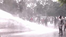 Police disperse protesters with water cannons, sound grenades
